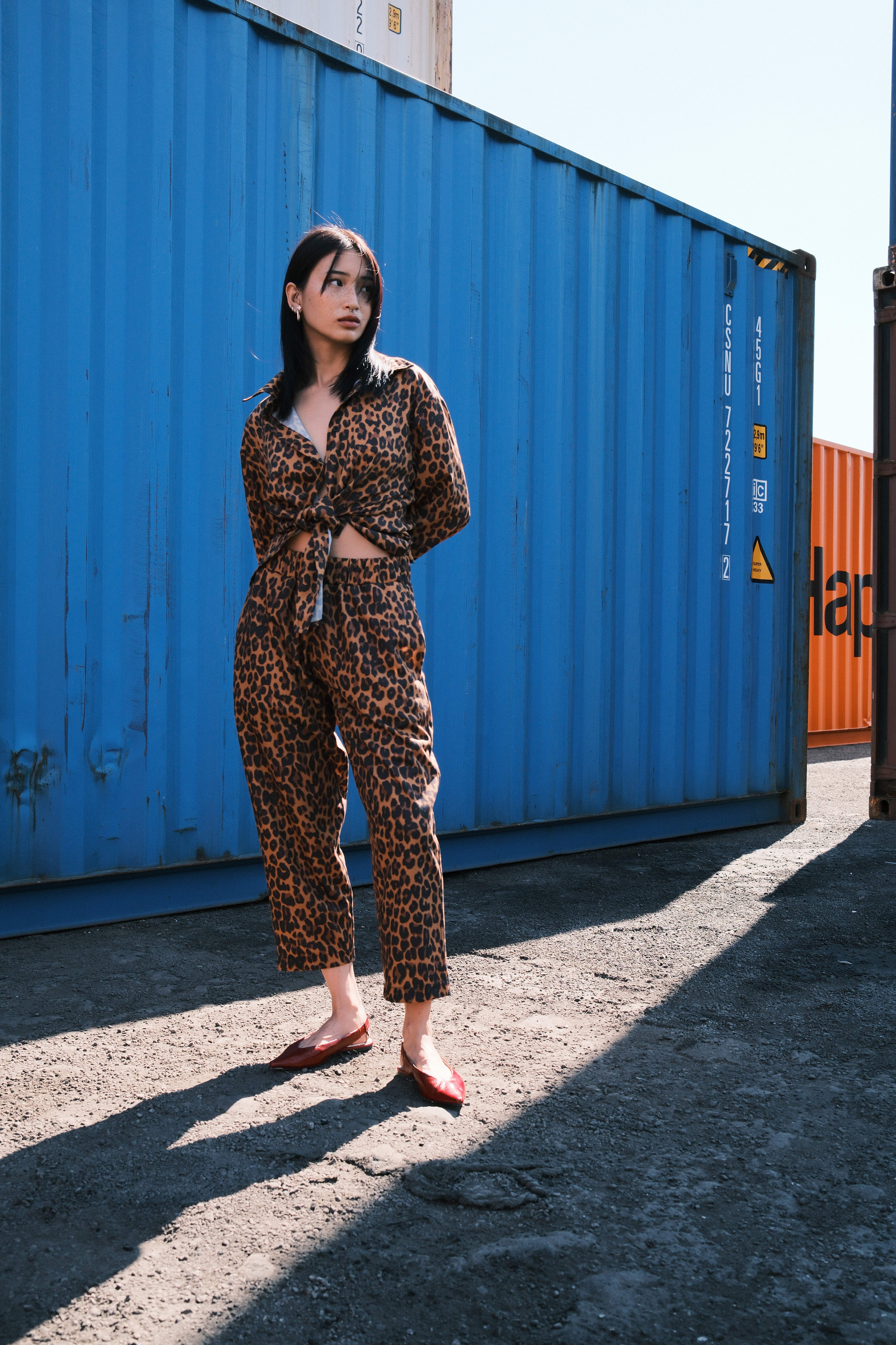 Model in a matching floral track set against a green container