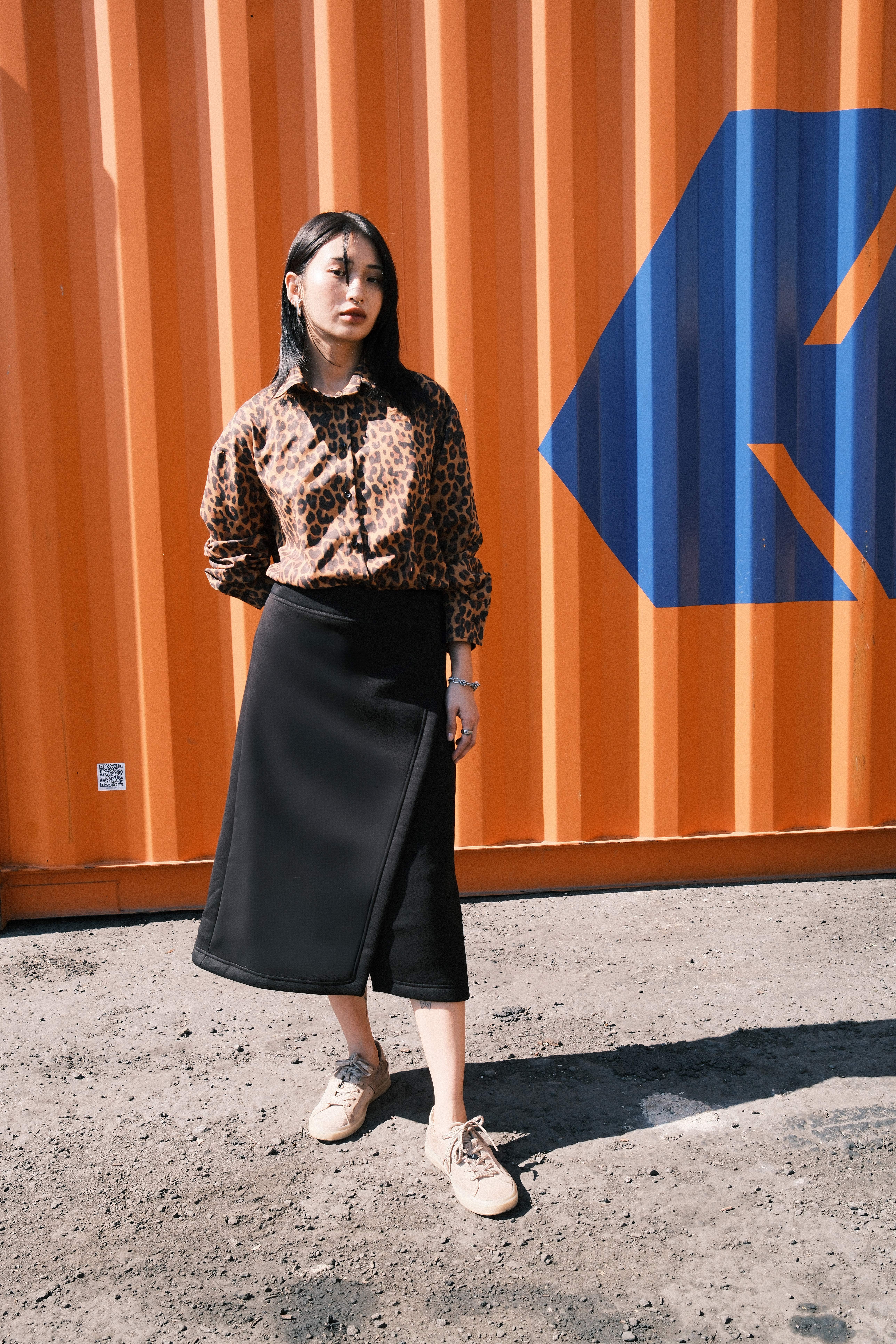 Model in a matching floral track set against a green container