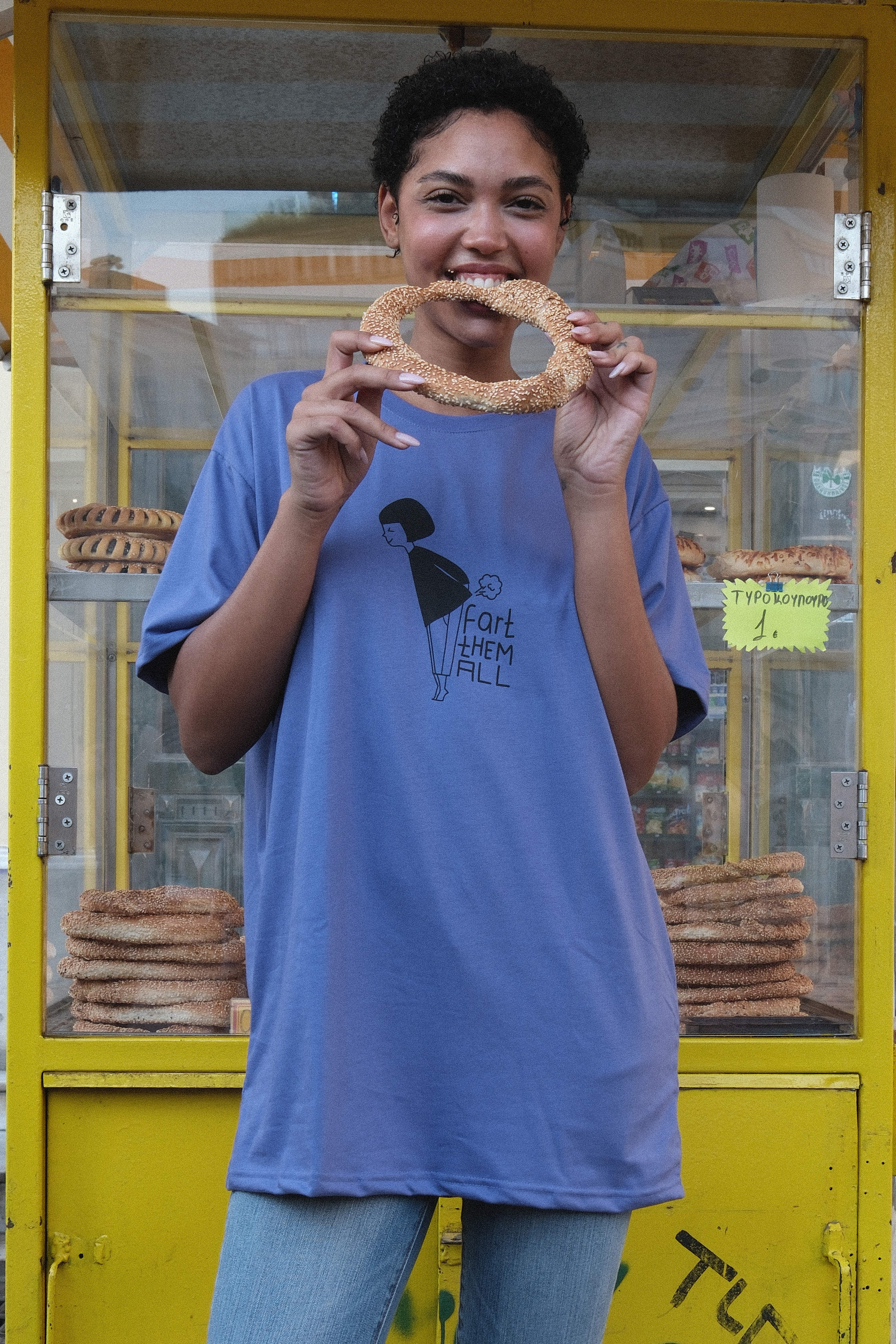 Model pulling a red MUSE logo tee up over her face