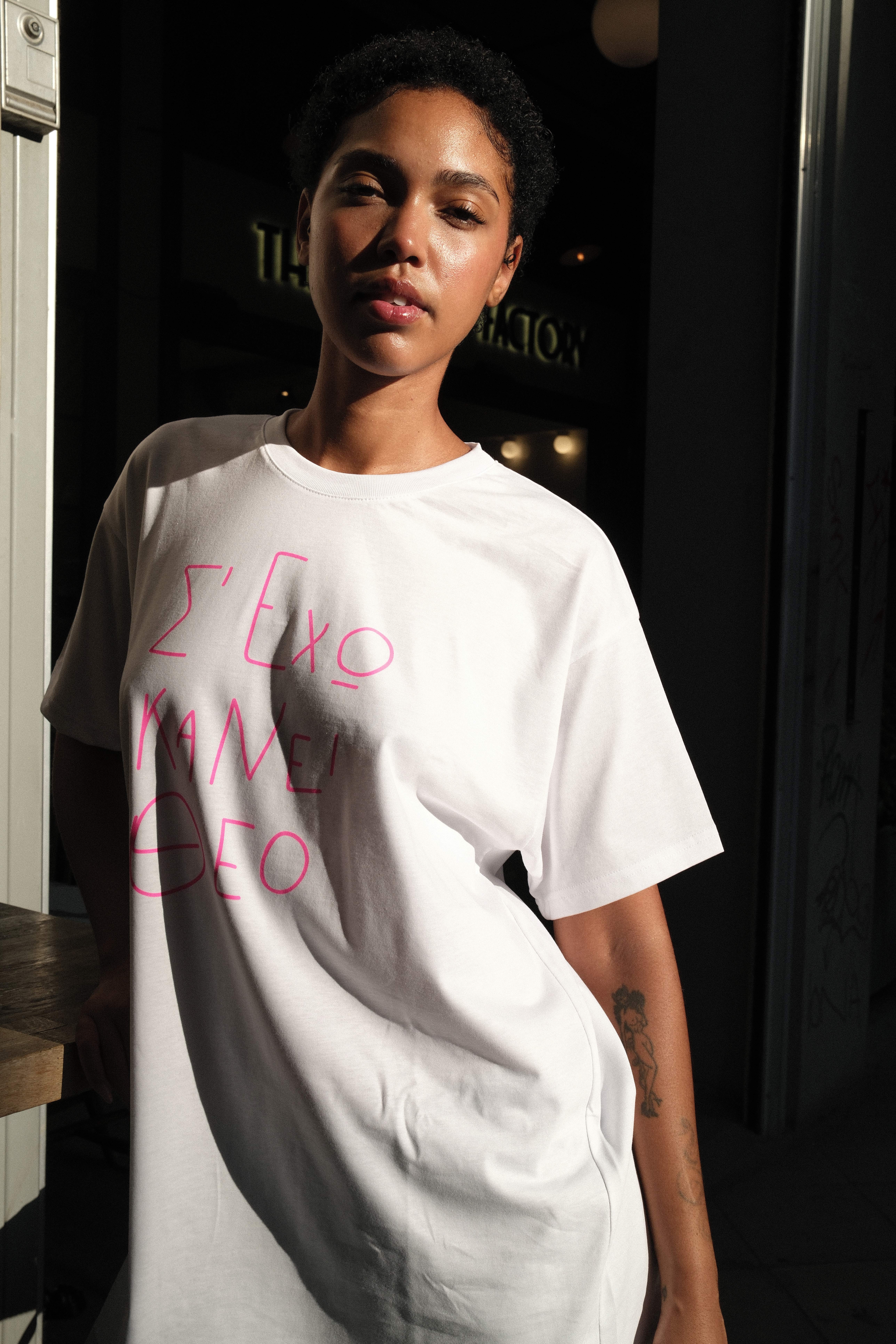 Model pulling a red MUSE logo tee up over her face